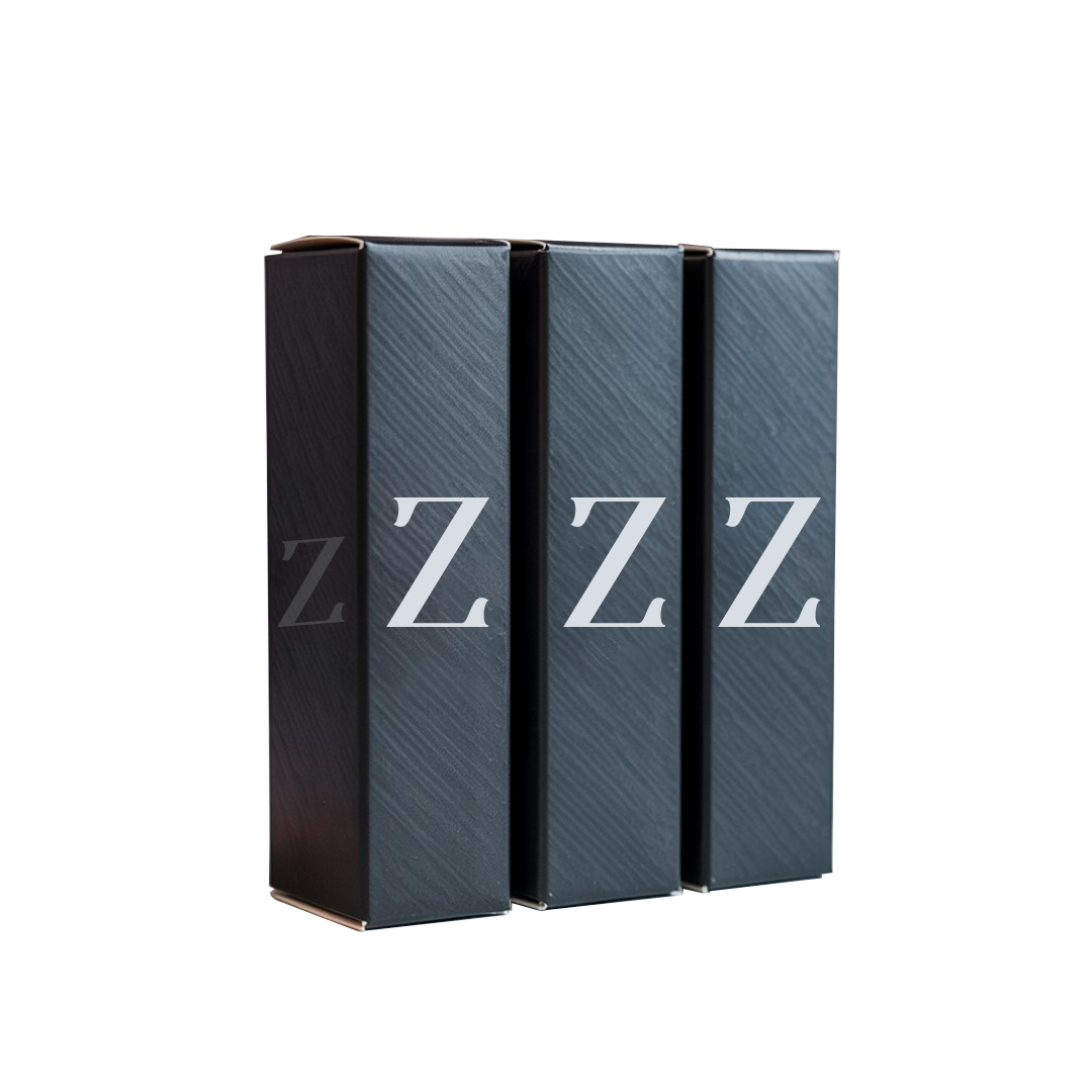Three black mascara boxes featuring the letter 